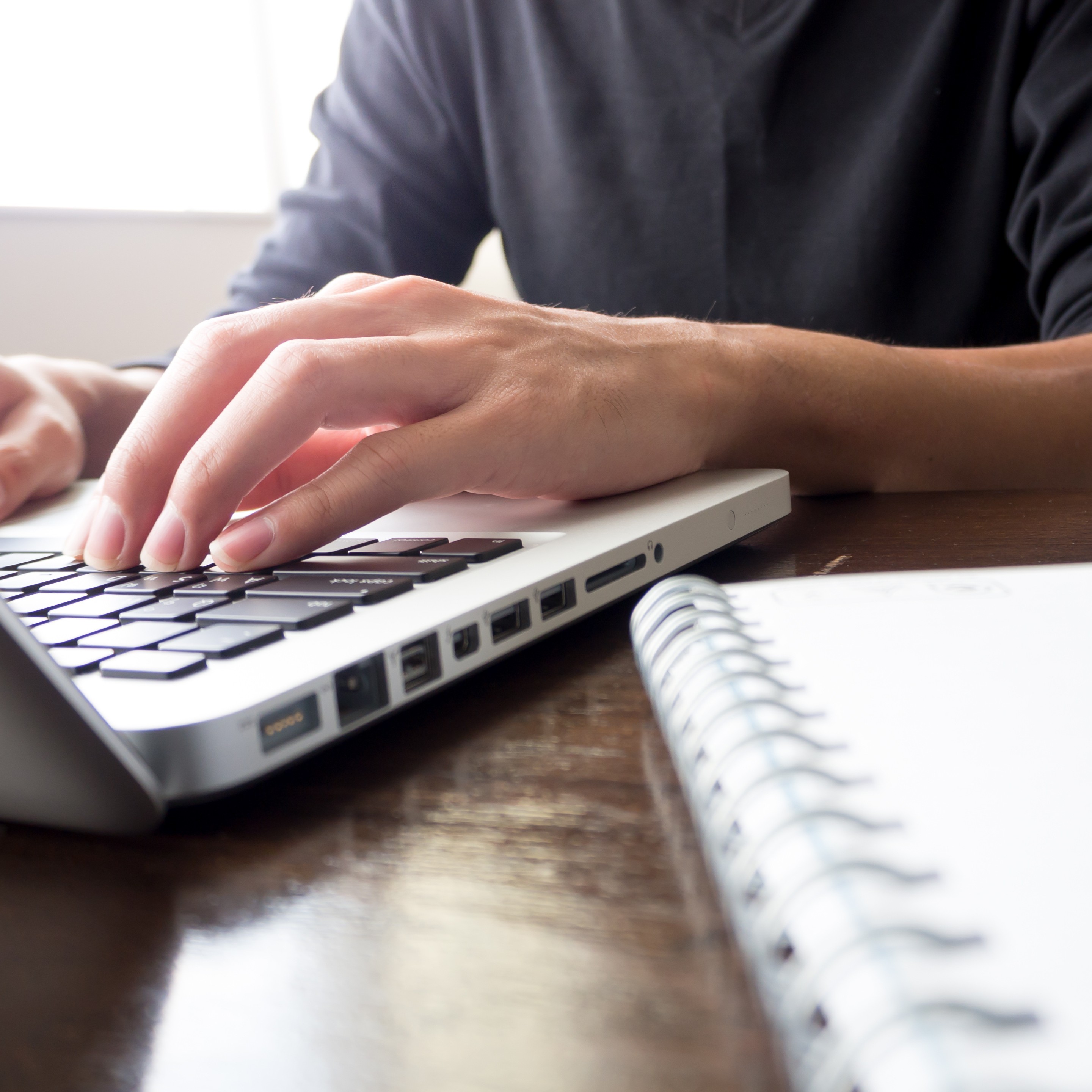 man using a laptop to look at finance options for e-Track
